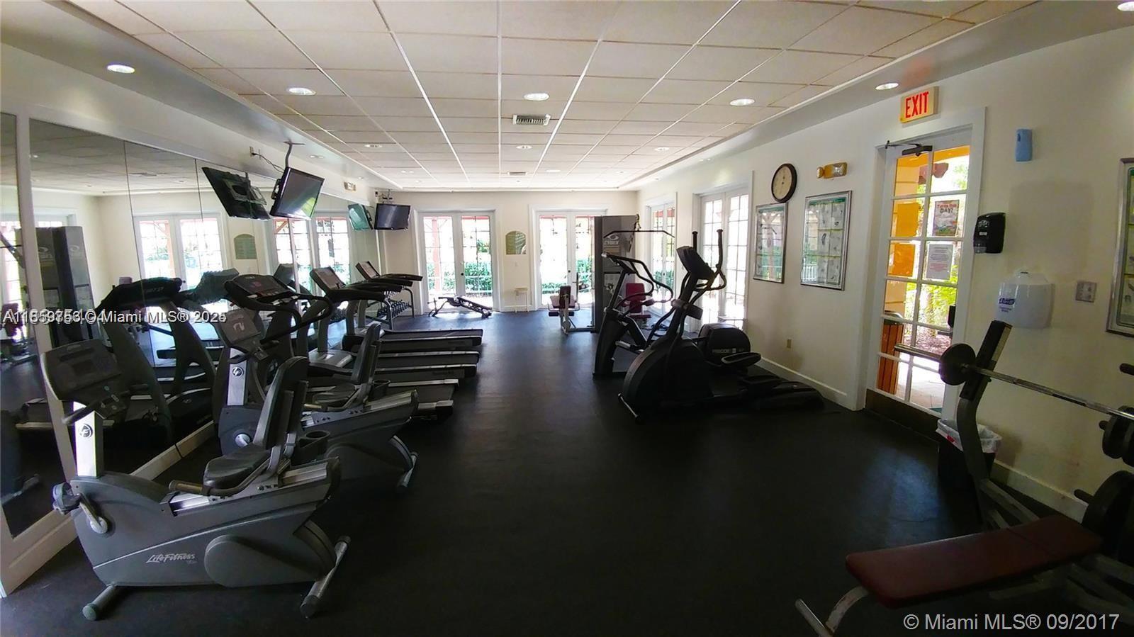 6790 West Sample Road, Unit 6790 Coral Springs, FL 33067 - Photo 4 of 26 a view of a room with gym equipment