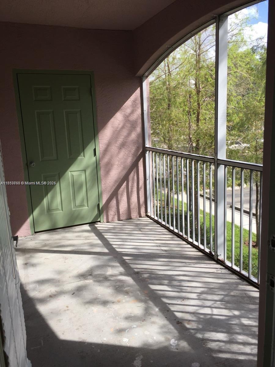 6790 West Sample Road, Unit 6790 Coral Springs, FL 33067 - Photo 7 of 26 a view of a balcony with wooden floor