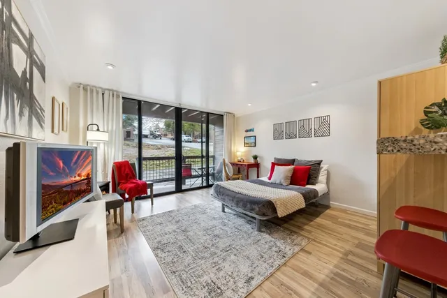 a living room with furniture and a floor to ceiling window