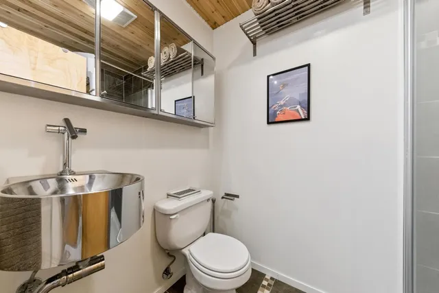 a white toilet sitting next to a window