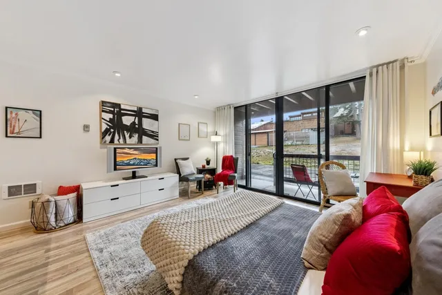 a bed room with a bed and a large window