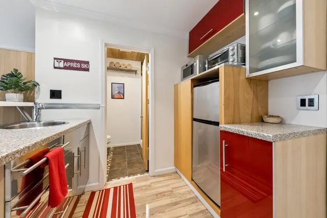 a kitchen with stainless steel appliances granite countertop a refrigerator and a sink