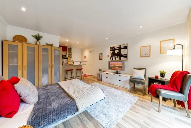 a living room with furniture and a wooden floor