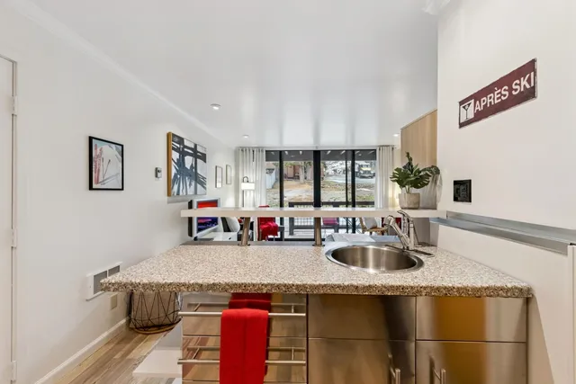 a kitchen with granite countertop a sink cabinets and window