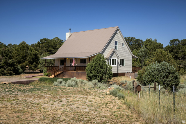 684 Blue Mountain Ridge Monticello, UT 84535 - Photo 6 of 71 View of property exterior with a chimney and view of scattered trees