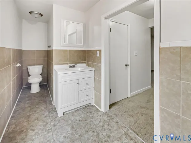 a bathroom with a sink toilet and vanity