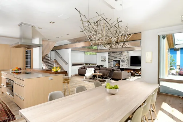 a bathroom with a tub a sink and a large mirror