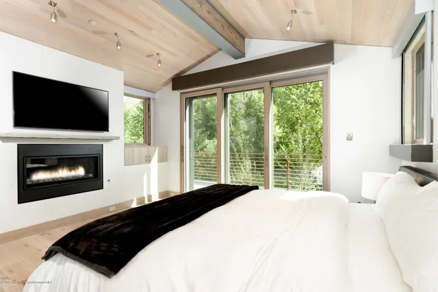 a spacious bathroom with a tub sink and mirror
