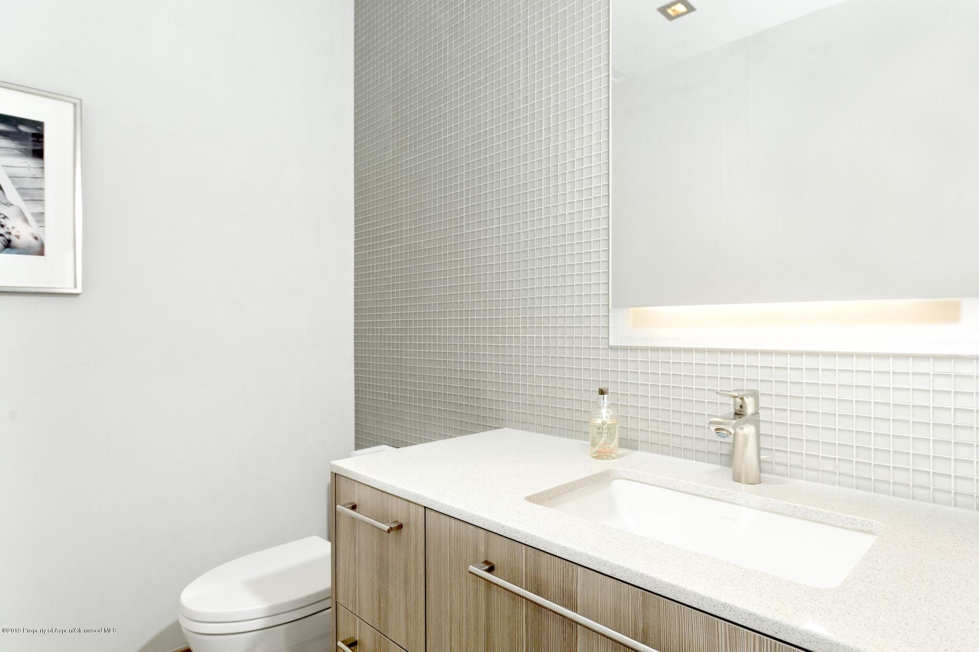 217 South 3rd Street Aspen, CO 81611 - Photo 15 of 32 a bathroom with a sink a toilet and a mirror