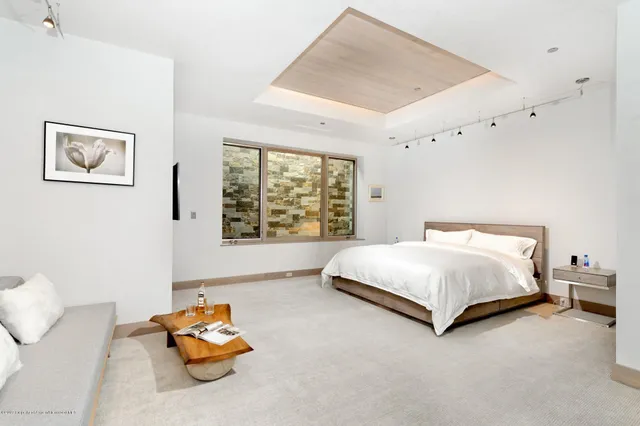 a bathroom with a sink a toilet a mirror and shower