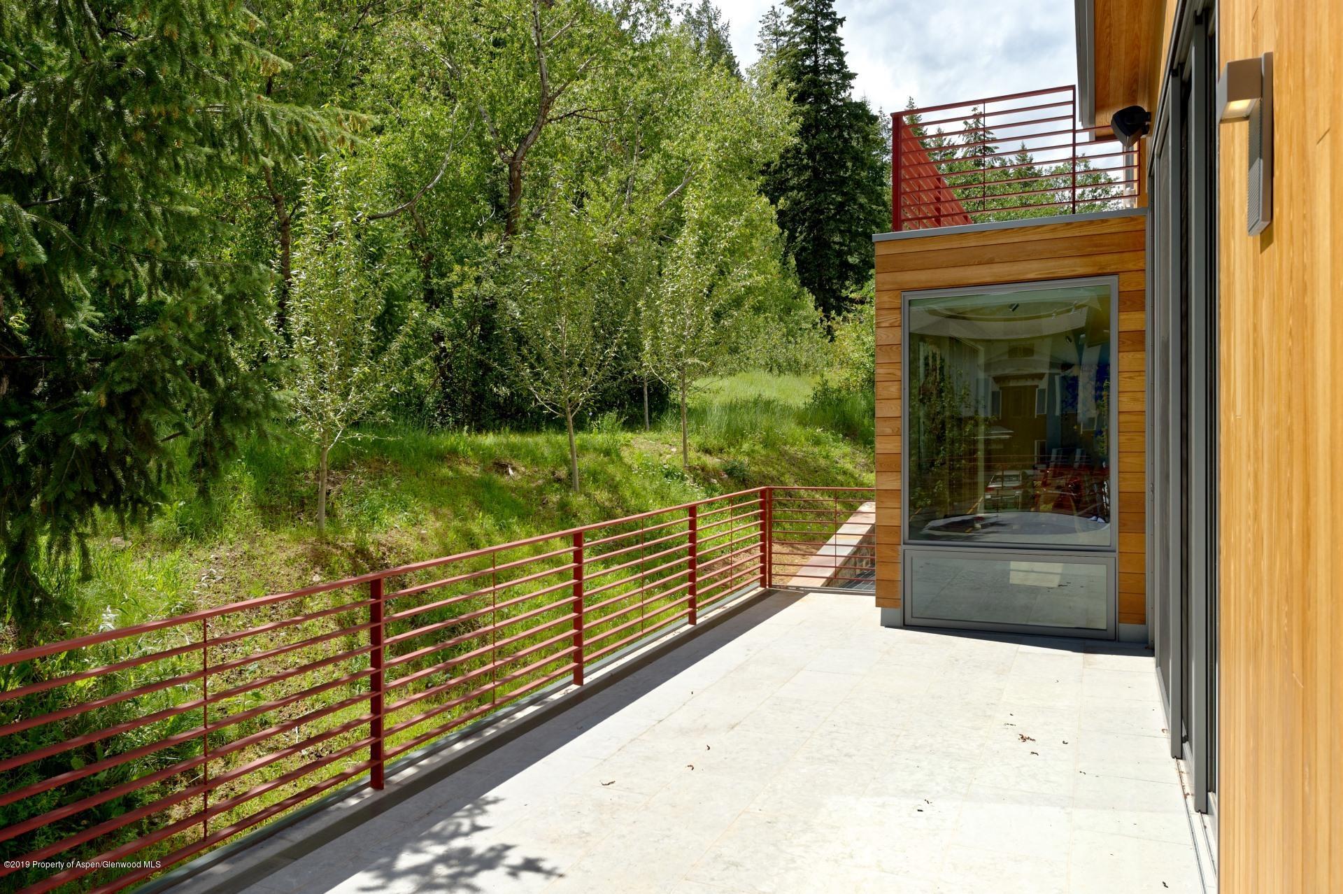217 South 3rd Street Aspen, CO 81611 - Photo 29 of 32 a view of a balcony with floor to ceiling windows and yard