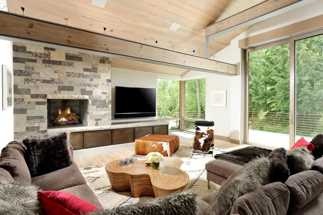 a living room with furniture a large window and a flat screen tv
