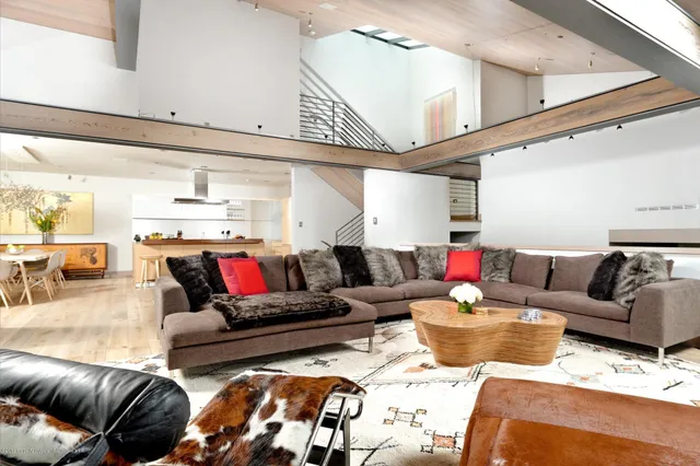 a living room with furniture and view of kitchen