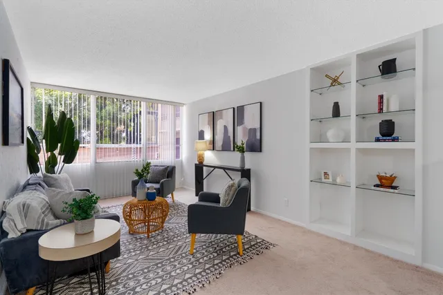 a living room with furniture and a potted plant