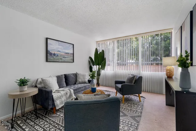 a bedroom with a bed a lamp and a window