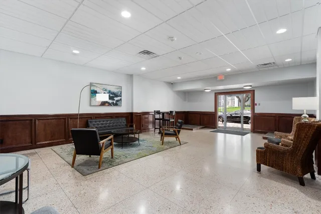 a living room with furniture and a lamp