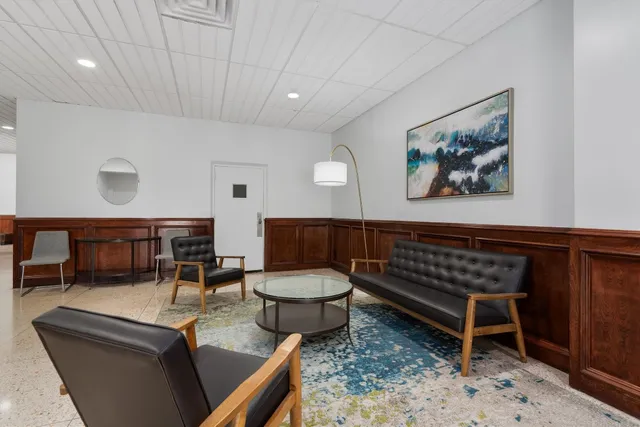 a view of a building with backyard and seating space