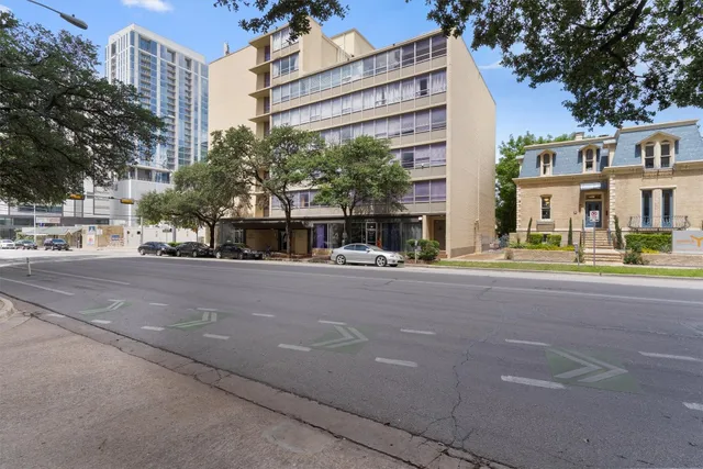 a view of a street with a building in the background
