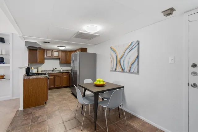 a kitchen with granite countertop stainless steel appliances and wooden cabinets