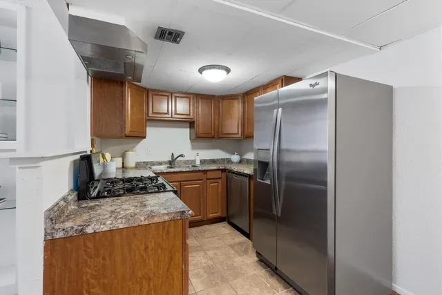 a kitchen with granite countertop a sink and cabinets
