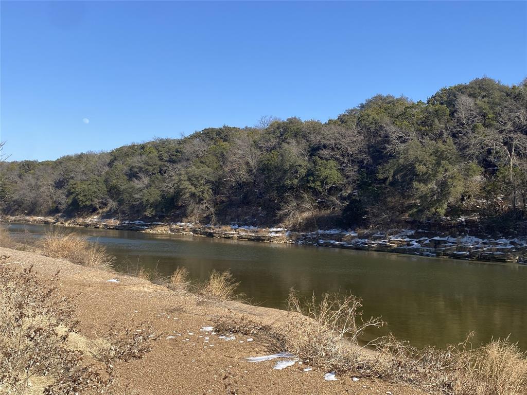 Lot 133 River Shoals Weatherford, TX 76088 - Photo 11 of 20 a view of a lake with a mountain in the background