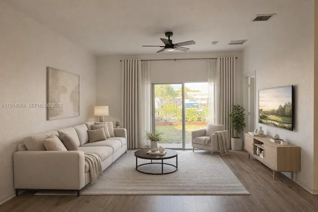 a living room with furniture and a flat screen tv