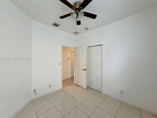 a view of a room with window and a chandelier fan