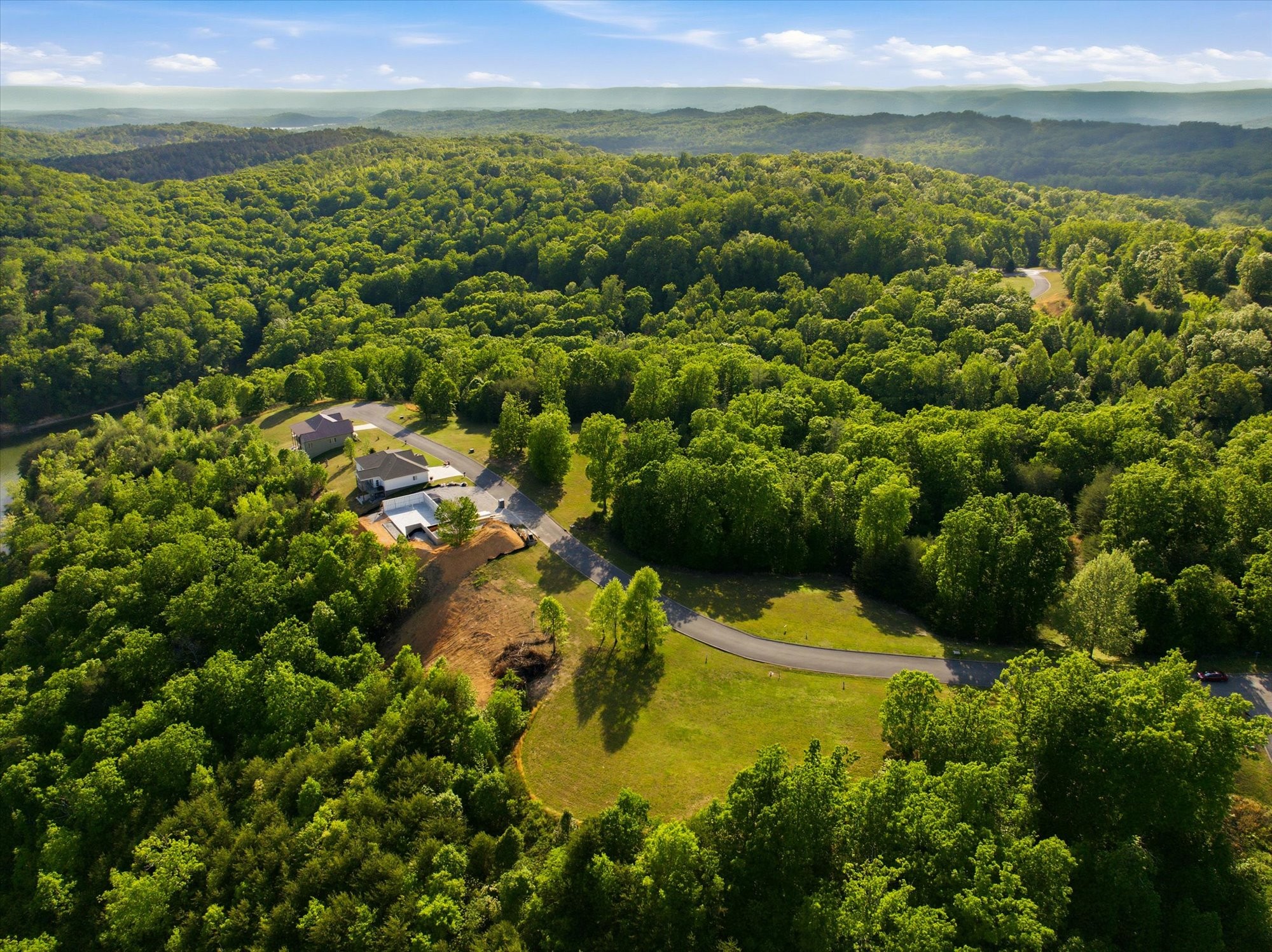 240 River Run Trail Spring City, TN 37381 - Photo 8 of 24 a view of a lake with a houses