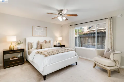 a spacious bedroom with a bed and a window