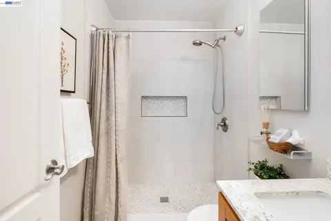 a bathroom with a shower curtain and a sink