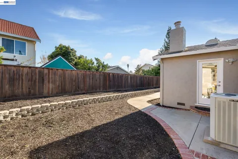 a backyard of a house with table and chairs