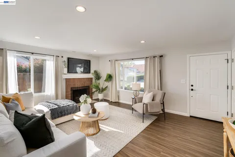 a living room with furniture and a fireplace