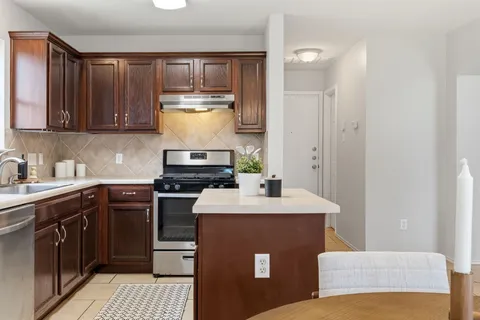 a kitchen with a sink and chairs