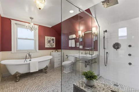 a spacious bathroom with a double vanity sink a mirror and a bathtub
