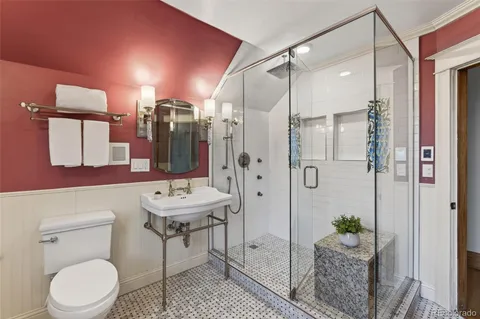 a bathroom with a sink toilet a shower and a mirror