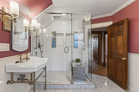 a bathroom with a sink shower and a mirror