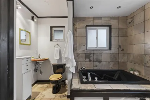 a bathroom with a toilet a sink and bathtub