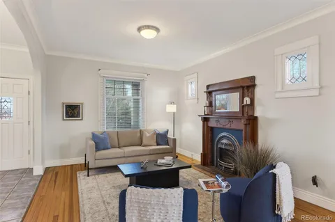 a living room with furniture a window and a fireplace