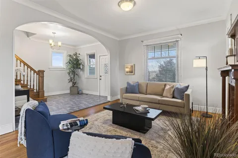 a living room with furniture and wooden floor