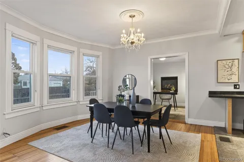 a view of a dining room with furniture window and wooden floor