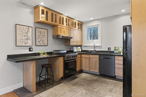 a kitchen that has a sink and a stove in it