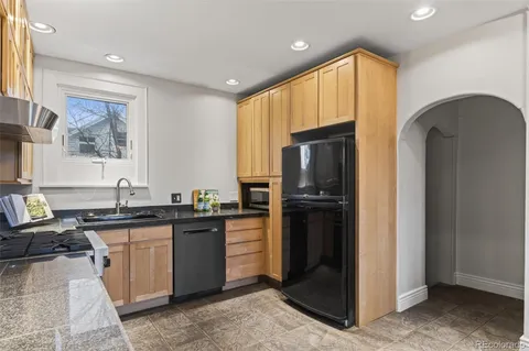 a kitchen with a refrigerator and a sink