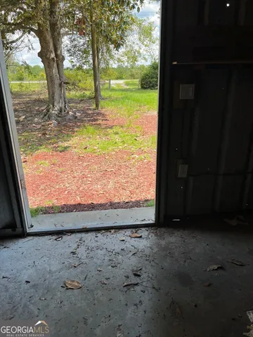 a view of a backyard with large trees