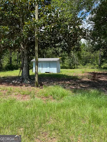 a view of empty room with wooden floor and a floor to ceiling window