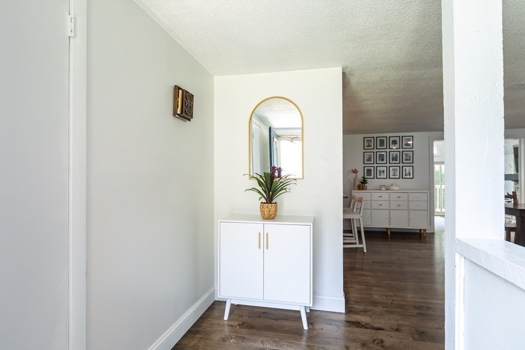 17 Lindsay Road Billerica, MA 01821 - Photo 15 of 42 a view of a hallway with wooden floor and a bathroom