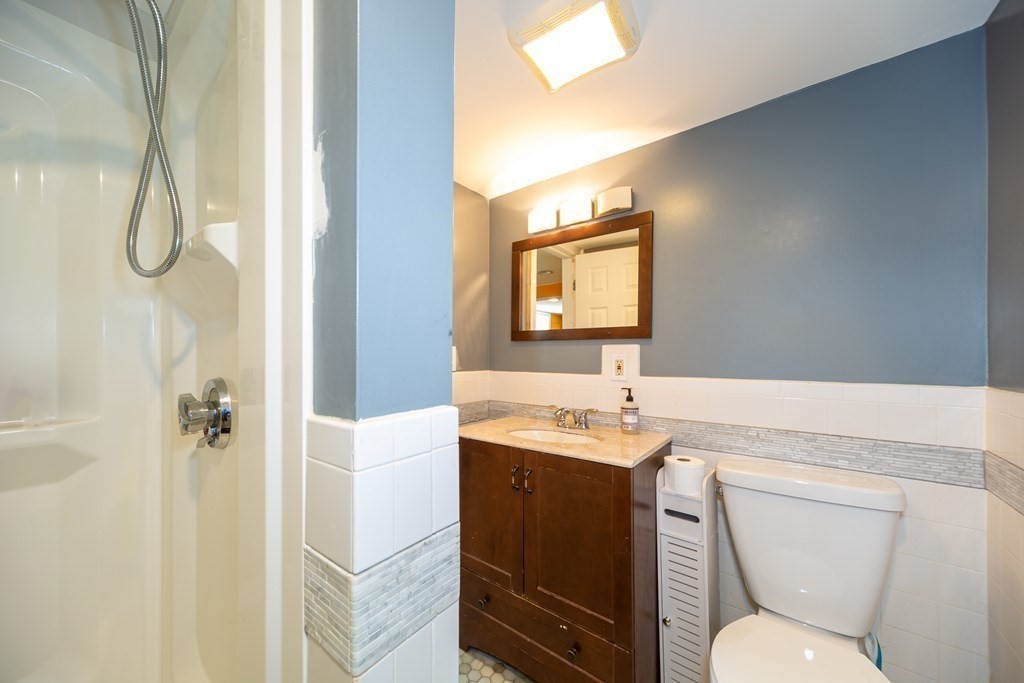17 Lindsay Road Billerica, MA 01821 - Photo 27 of 42 a bathroom with a toilet sink vanity shower and mirror