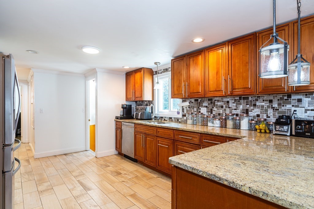 17 Lindsay Road Billerica, MA 01821 - Photo 5 of 42 a kitchen with stainless steel appliances granite countertop a sink a stove and a wooden cabinets