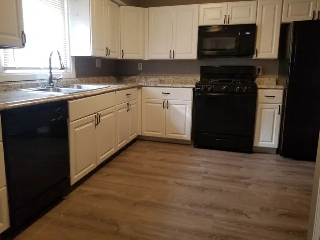 a kitchen with a sink appliances and cabinets