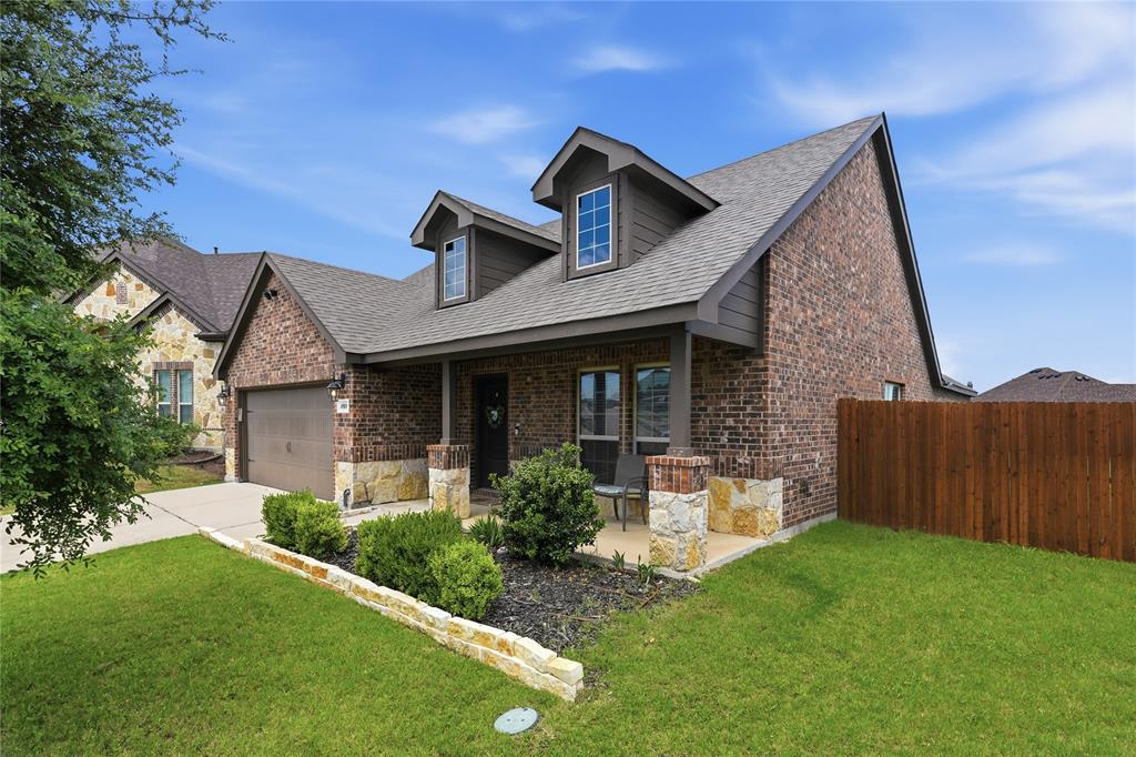 10101 Travis Road Little Elm, TX 75068 - Photo 2 of 26 a front view of a house with garden