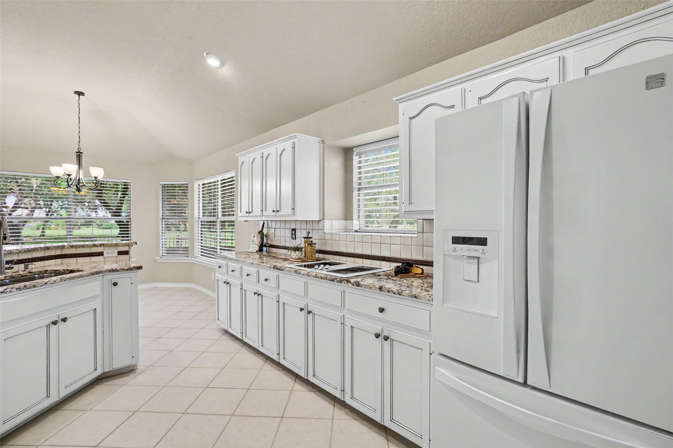 30107 Hamlet Circle Georgetown, TX 78628 - Photo 11 of 40 A well-appointed kitchen showcasing elegant white cabinetry and durable tiled flooring.